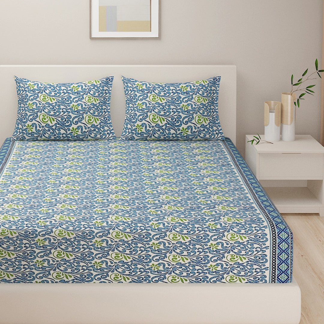 ethnic floral bedding, 120TC cotton bedsheet, vibrant bedroom decor, blue and green bedspread, ethnic motif linen, comfortable stylish bedding, premium cotton bedding set, intricate floral design, serene bedroom textiles, bold pattern bed linen