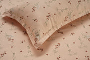 Meadows Blush bedding, floral peach cotton satin, hypoallergenic bed set, all-season comfort bedding, serene botanical design, luxury bedroom textiles, soft satin sheets, durable and soft bedspread, elegant meadow-inspired linens, peaceful bedroom aesthetic.